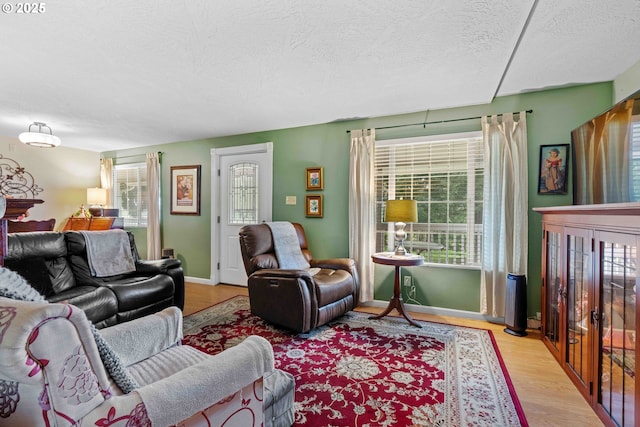 1042 W State Route 4, Cathlamet, WA 98612 - living area with a textured ceiling, light wood finished floors, and a healthy amount of sunlight