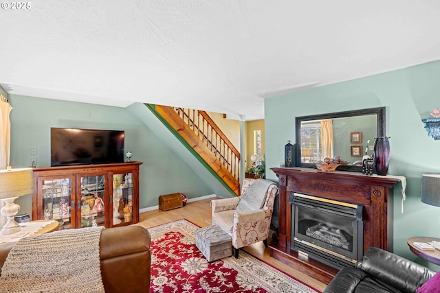 1042 W State Route 4, Cathlamet, WA 98612 - living room with wood finished floors, a fireplace, and stairway