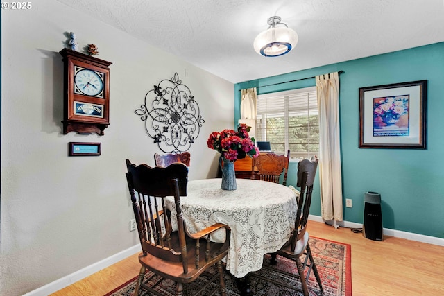 1042 W State Route 4, Cathlamet, WA 98612 - dining space featuring a textured ceiling, baseboards, and light wood finished floors