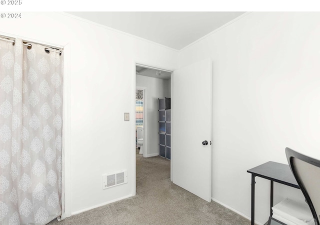 interior space featuring crown molding and light colored carpet