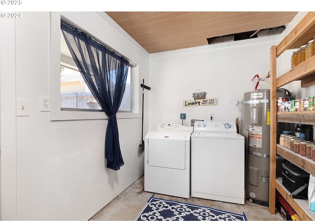 clothes washing area featuring wooden ceiling, washer and clothes dryer, and strapped water heater