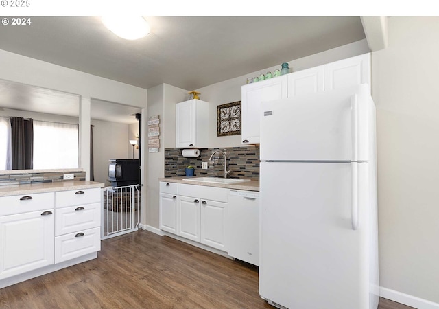 kitchen featuring white appliances, sink, white cabinetry, dark wood-type flooring, and decorative backsplash