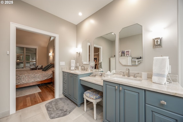 bathroom featuring vanity, baseboards, tile patterned flooring, and connected bathroom