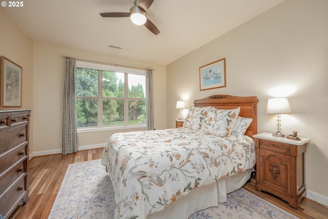 bedroom with visible vents, light wood-type flooring, and baseboards