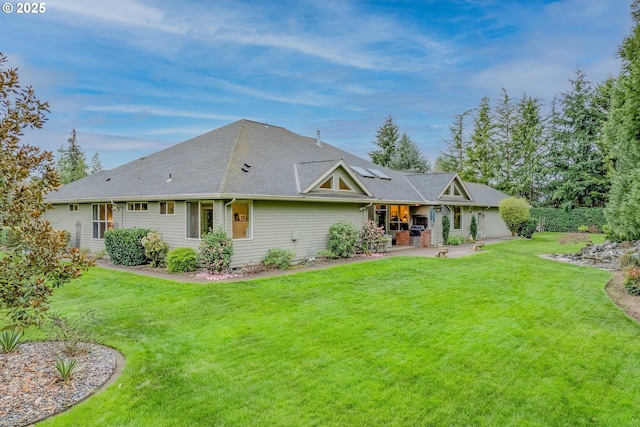 back of house with a patio and a lawn