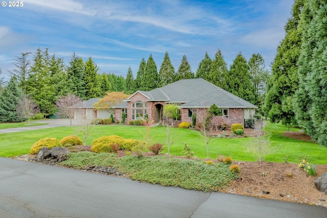 ranch-style house with brick siding, a front lawn, an attached garage, and driveway