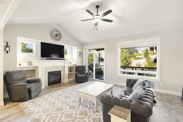 16290 SE Eckert Ln, Damascus, OR 97089 - living room featuring wood finished floors, a ceiling fan, a glass covered fireplace, and lofted ceiling