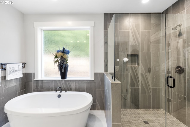 16290 SE Eckert Ln, Damascus, OR 97089 - bathroom featuring a freestanding tub, tile walls, a stall shower, healthy amount of natural light, and wainscoting