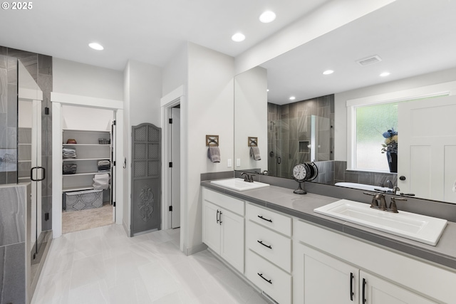 16290 SE Eckert Ln, Damascus, OR 97089 - bathroom featuring a shower stall, double vanity, a spacious closet, and recessed lighting