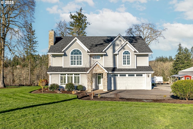 view of front of home featuring a garage and a front yard