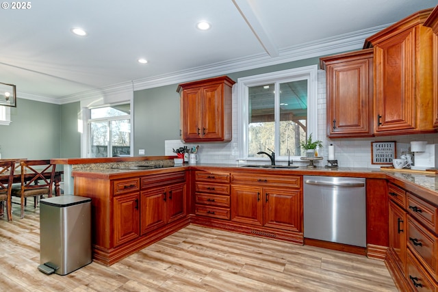 kitchen with sink, crown molding, dishwasher, kitchen peninsula, and decorative backsplash