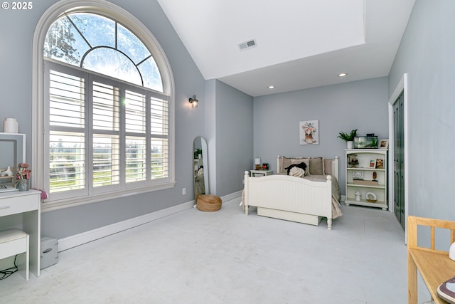 bedroom with vaulted ceiling and multiple windows