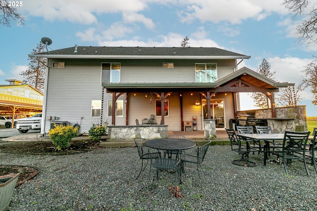 back of house with a patio area and an outdoor bar