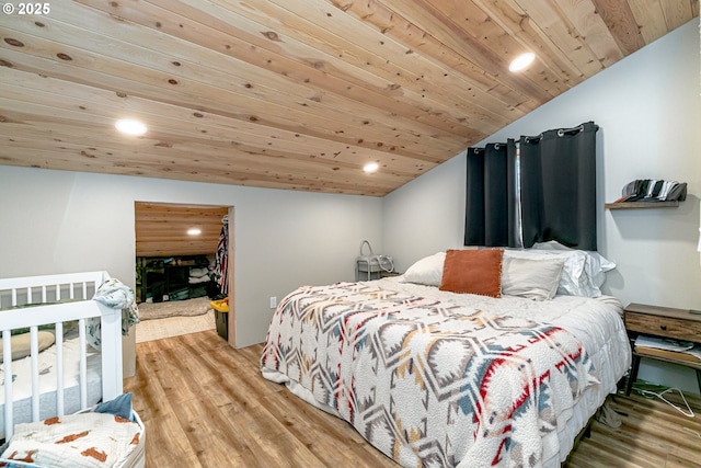 bedroom featuring lofted ceiling, hardwood / wood-style floors, and wooden ceiling