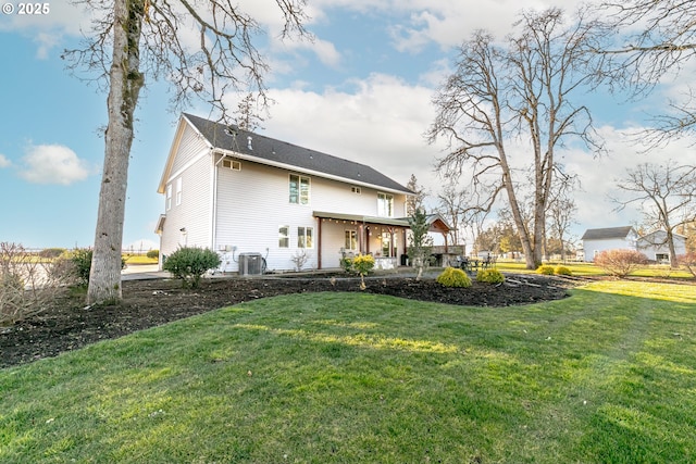 back of property featuring central AC, a patio area, and a lawn