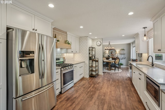 16318 SW Wright St, Beaverton, OR 97007 - kitchen featuring stainless steel appliances, backsplash, white cabinets, and recessed lighting