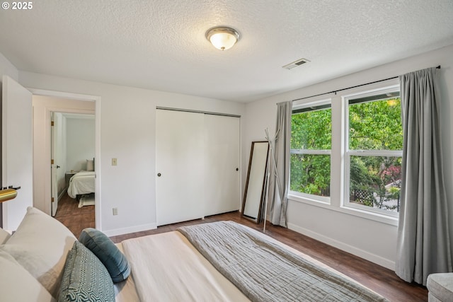 16318 SW Wright St, Beaverton, OR 97007 - bedroom featuring a textured ceiling, a closet, and wood finished floors