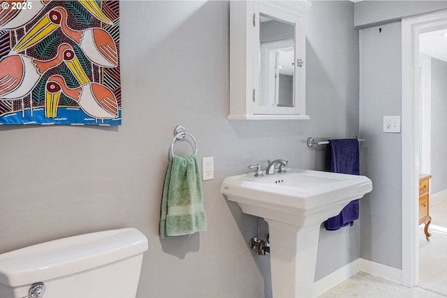 2445 SE 76th Ave, Portland, OR 97206 - bathroom featuring baseboards, toilet, and a sink
