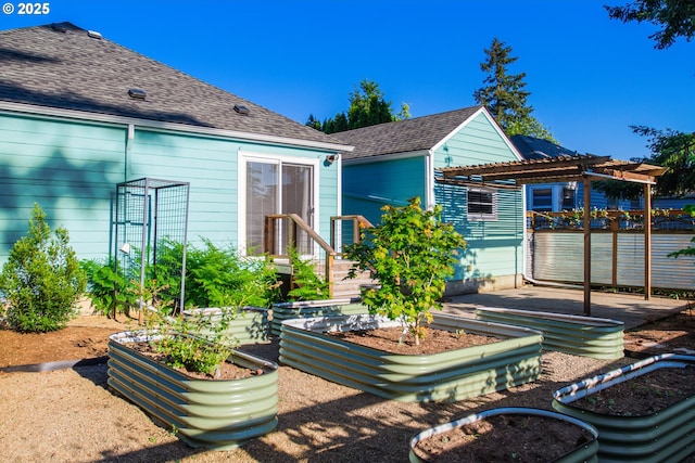 2445 SE 76th Ave, Portland, OR 97206 - rear view of house featuring a garden, a shingled roof, and a pergola
