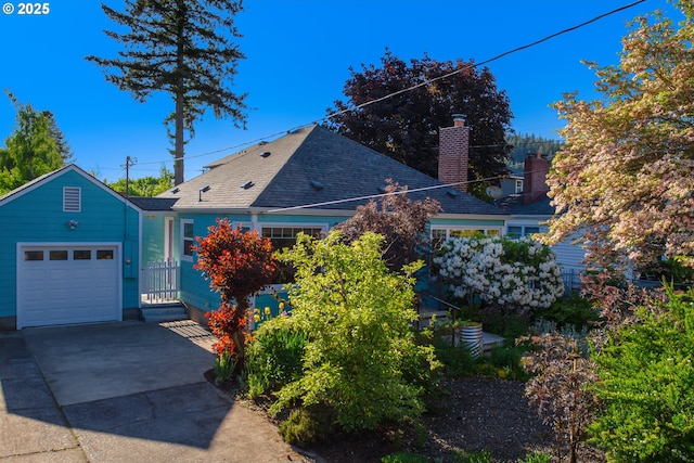 2445 SE 76th Ave, Portland, OR 97206 - view of front facade with driveway, a chimney, an attached garage, and a shingled roof