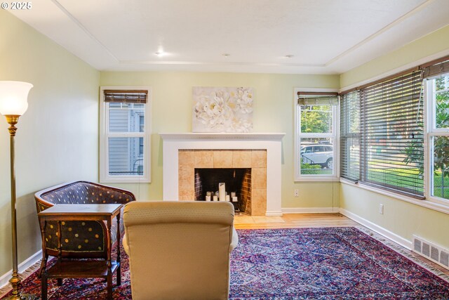 2445 SE 76th Ave, Portland, OR 97206 - living room featuring wood finished floors, baseboards, and a fireplace