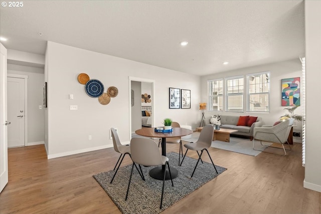 dining space featuring light wood-style floors, recessed lighting, and baseboards
