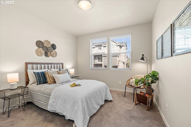 bedroom with carpet floors and baseboards