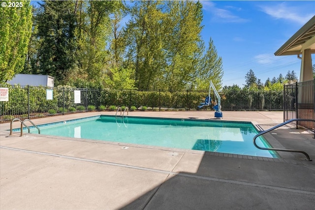 community pool featuring fence and a patio area