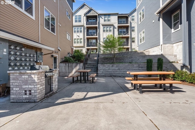 surrounding community featuring a patio area and outdoor dining area