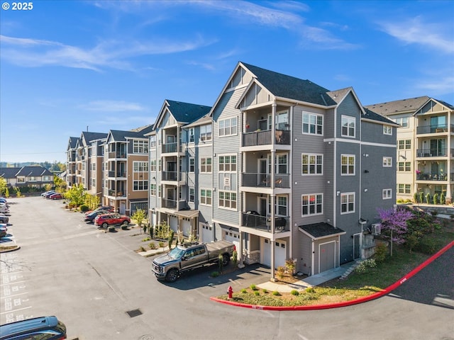 view of apartment building / complex featuring an attached garage