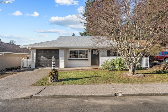 ranch-style house featuring a front lawn and a garage