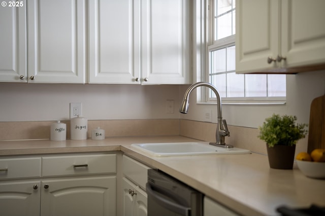 kitchen featuring sink, white cabinetry, and dishwasher