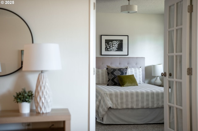 bedroom featuring carpet and a textured ceiling