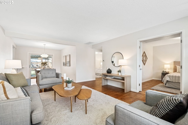 living room with a textured ceiling and hardwood / wood-style flooring