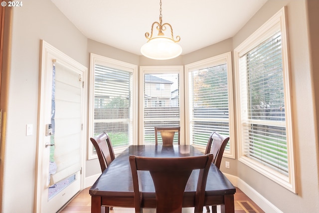 dining area featuring hardwood / wood-style flooring and a healthy amount of sunlight