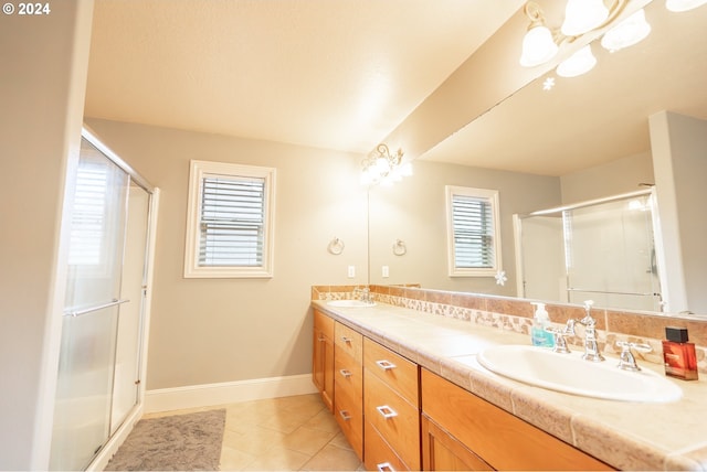 bathroom with tile patterned flooring, vanity, and an enclosed shower