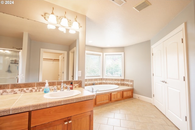 bathroom featuring vanity, separate shower and tub, and tile patterned floors