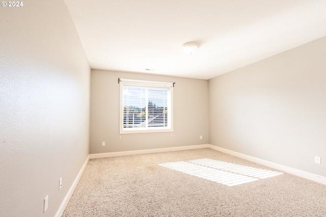 unfurnished room featuring carpet flooring