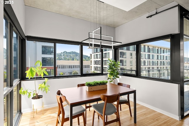 1830 NW Riverscape St Unit 406, Portland, OR 97209 - dining space with a city view, baseboards, and wood finished floors