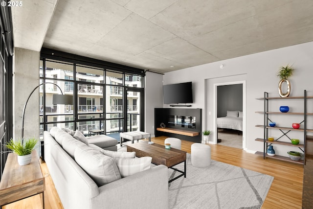 1830 NW Riverscape St Unit 406, Portland, OR 97209 - living area featuring expansive windows, baseboards, and wood finished floors