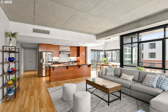 1830 NW Riverscape St Unit 406, Portland, OR 97209 - living area with a healthy amount of sunlight, light wood-style flooring, and visible vents