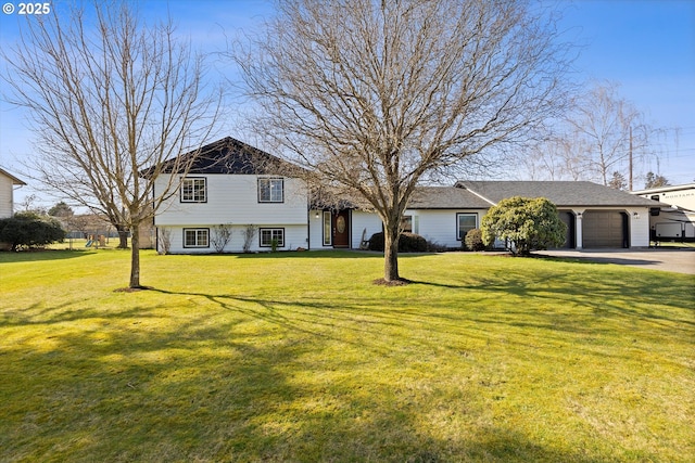 split level home featuring driveway, a front lawn, and an attached garage