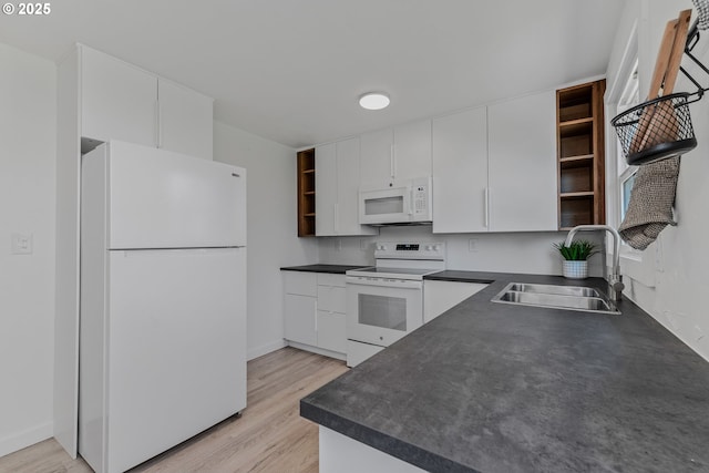kitchen with white appliances, a sink, open shelves, dark countertops, and white cabinets