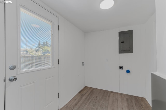 laundry room featuring electric panel, laundry area, wood finished floors, and electric dryer hookup