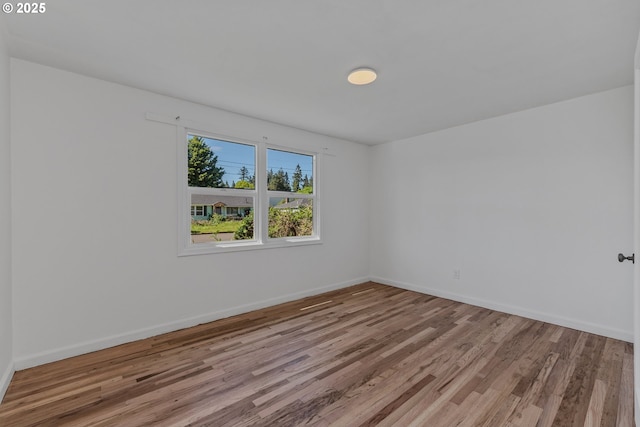 empty room with wood finished floors and baseboards