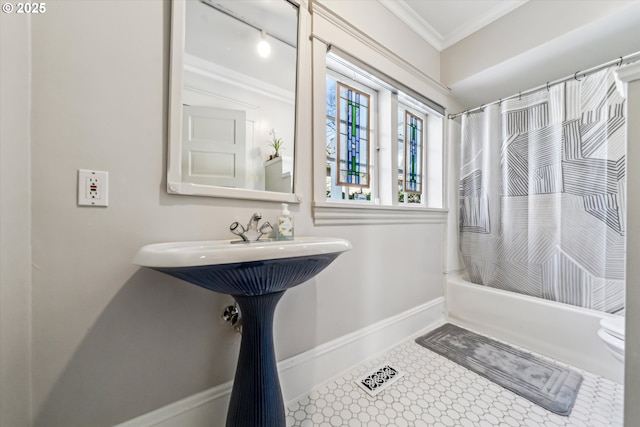 full bath with crown molding, baseboards, and shower / bath combo