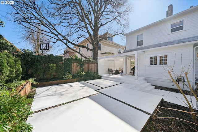back of house with a patio and fence
