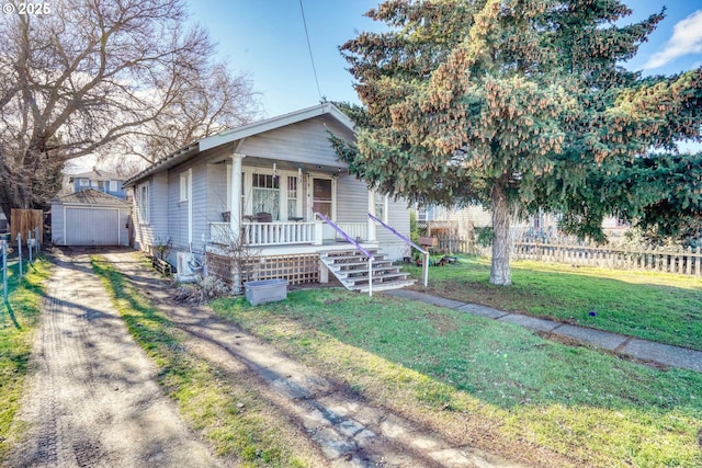 view of front of property with a porch, a front lawn, and a storage shed