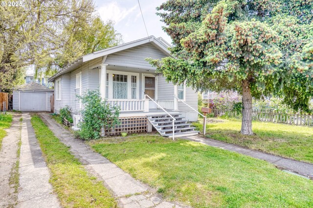 1206 E 9th St, The Dalles, OR 97058 - bungalow-style house with fence, an outdoor structure, a front yard, covered porch, and driveway