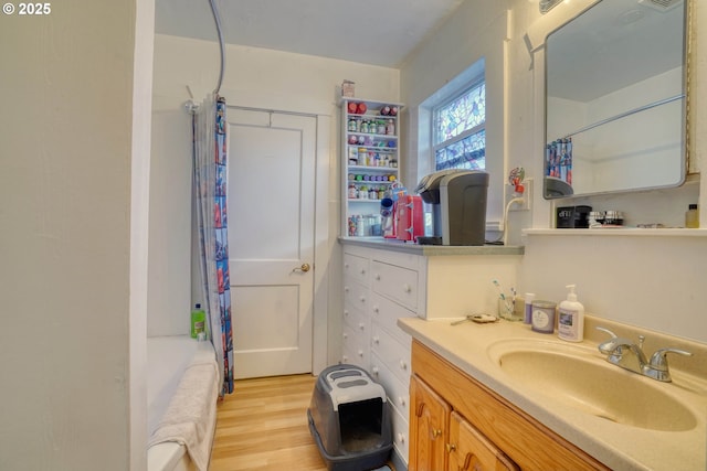 bathroom featuring vanity, hardwood / wood-style flooring, and shower / bath combination with curtain